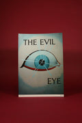 Book titled 'The Evil Eye' with a red background