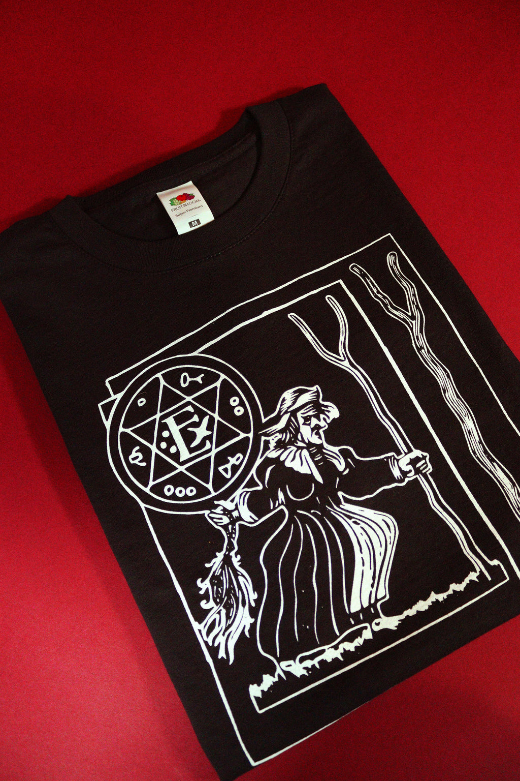 Black t-shirt with white graphic design on a red background