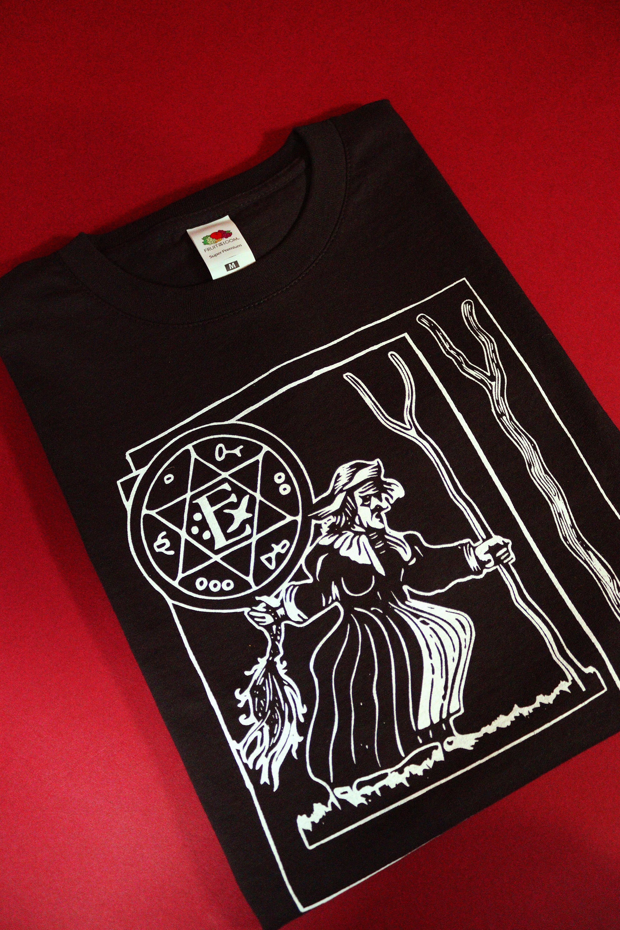 Black t-shirt with white graphic design on a red background