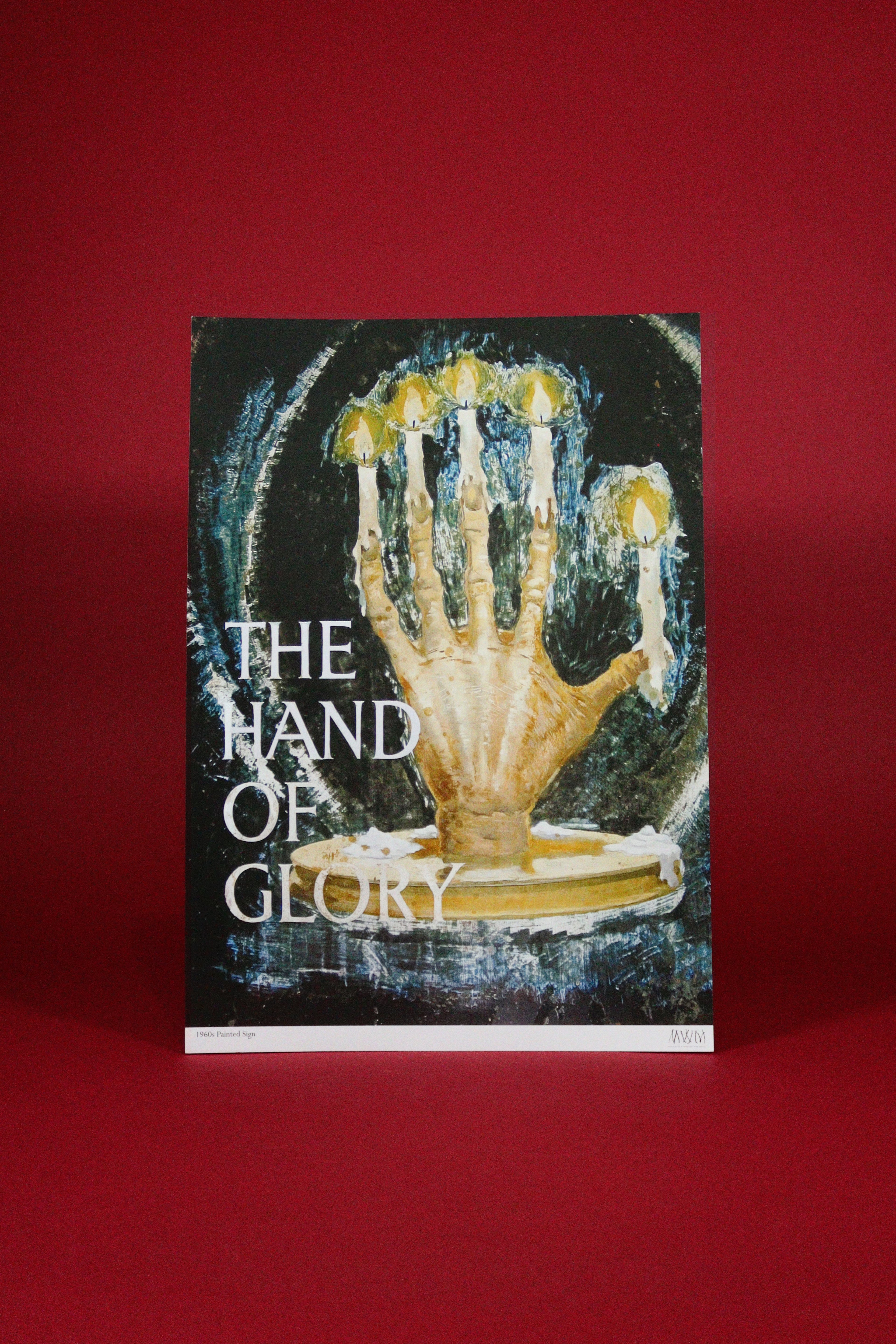 poster with the words  'The Hand of Glory' with a hand holding candles design on a red background