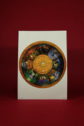 Decorative circular design on a white card with a red background