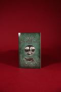 Book titled 'Spells from the Wise Woman's Cottage' on a red background
