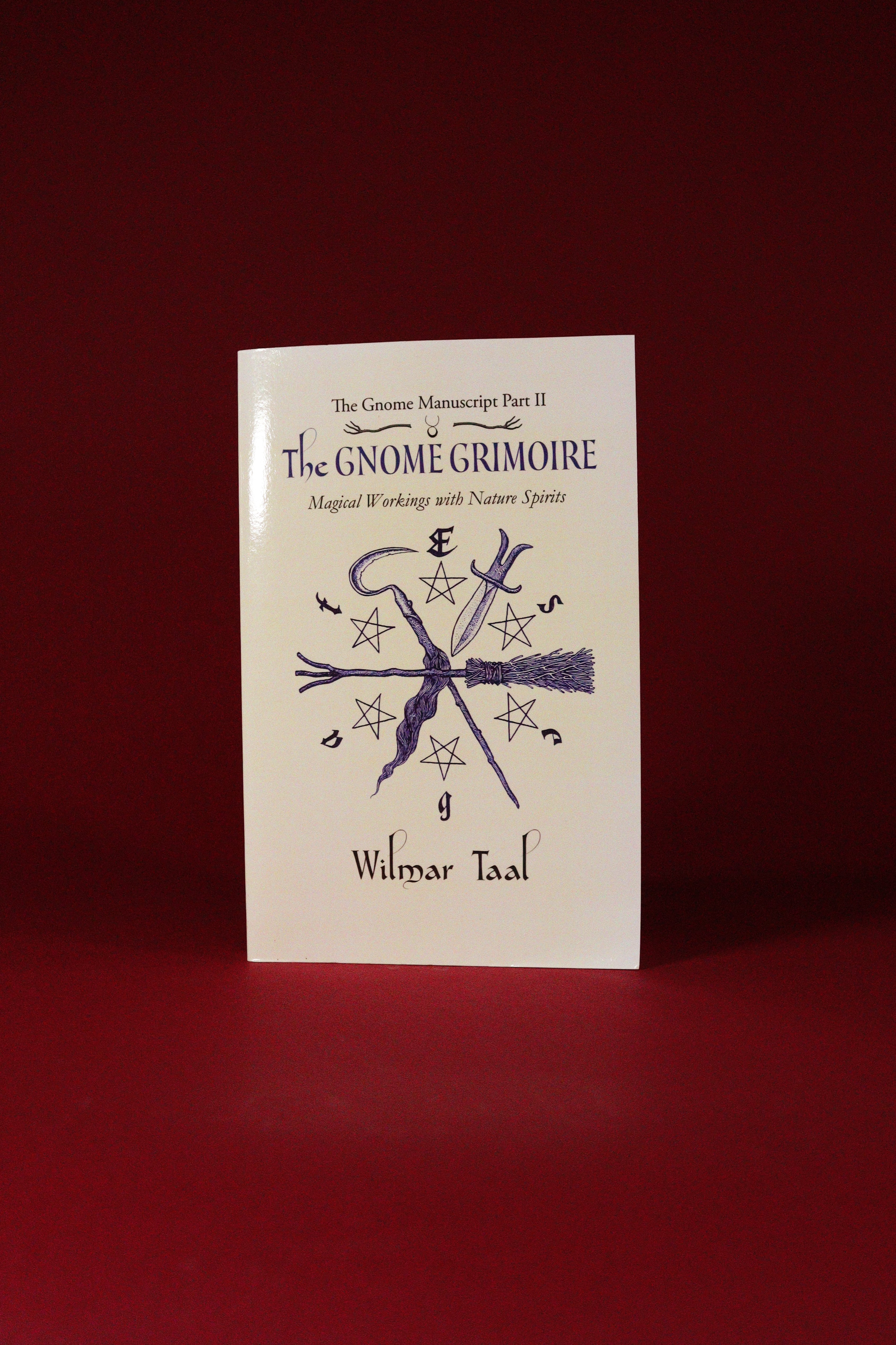 Book titled 'The Gnome Grimoire' by Wilmar Taal on a red background