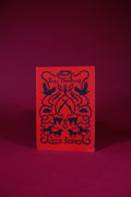 Red card with black text and design on a matching red background