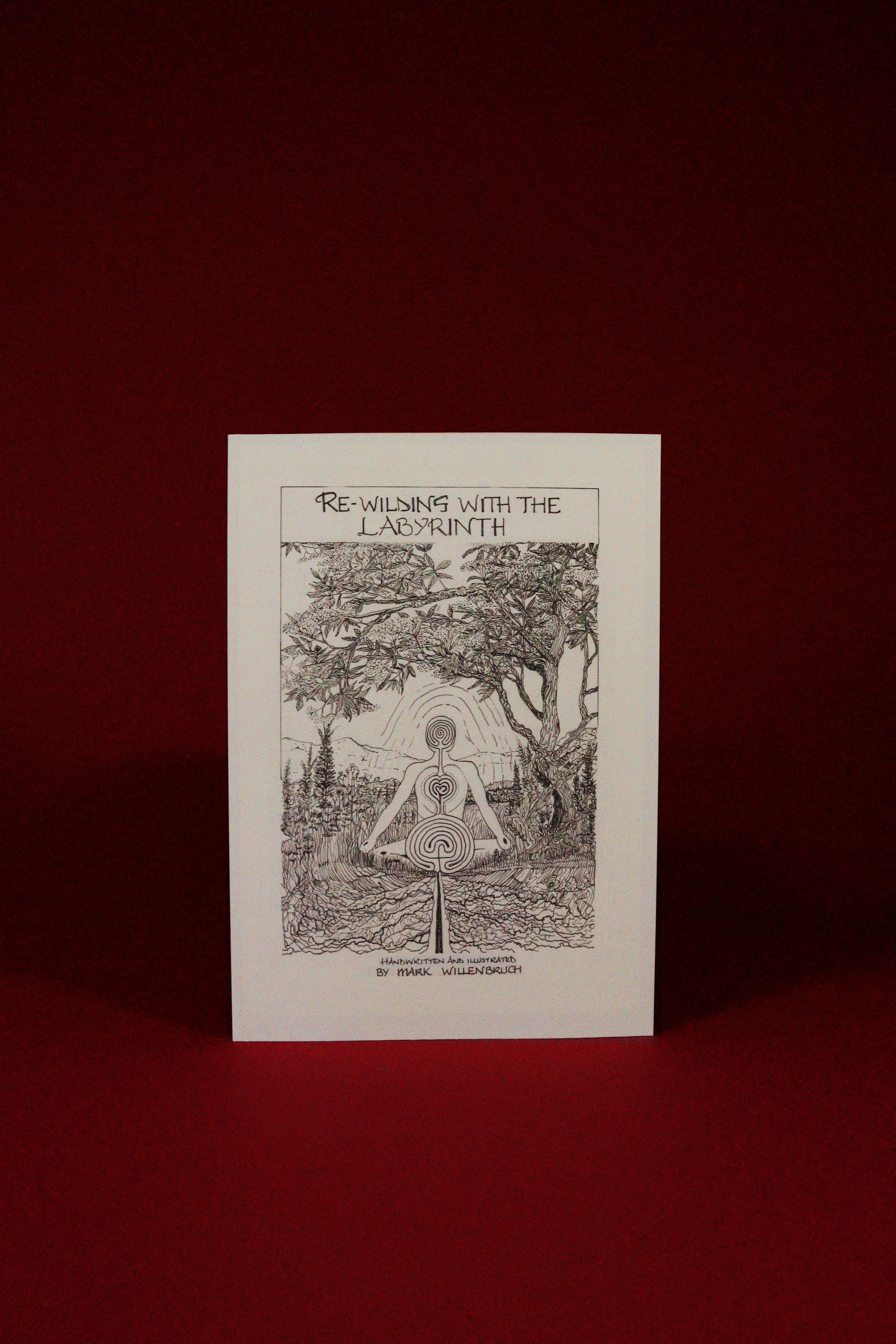 Booklet titled 'Re-Wilding with the Labyrinth' on a red background