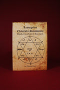 Book cover of 'Lemegeton Claviculae Salomonis The Little Key of Solomon' with mystical symbols on a red background