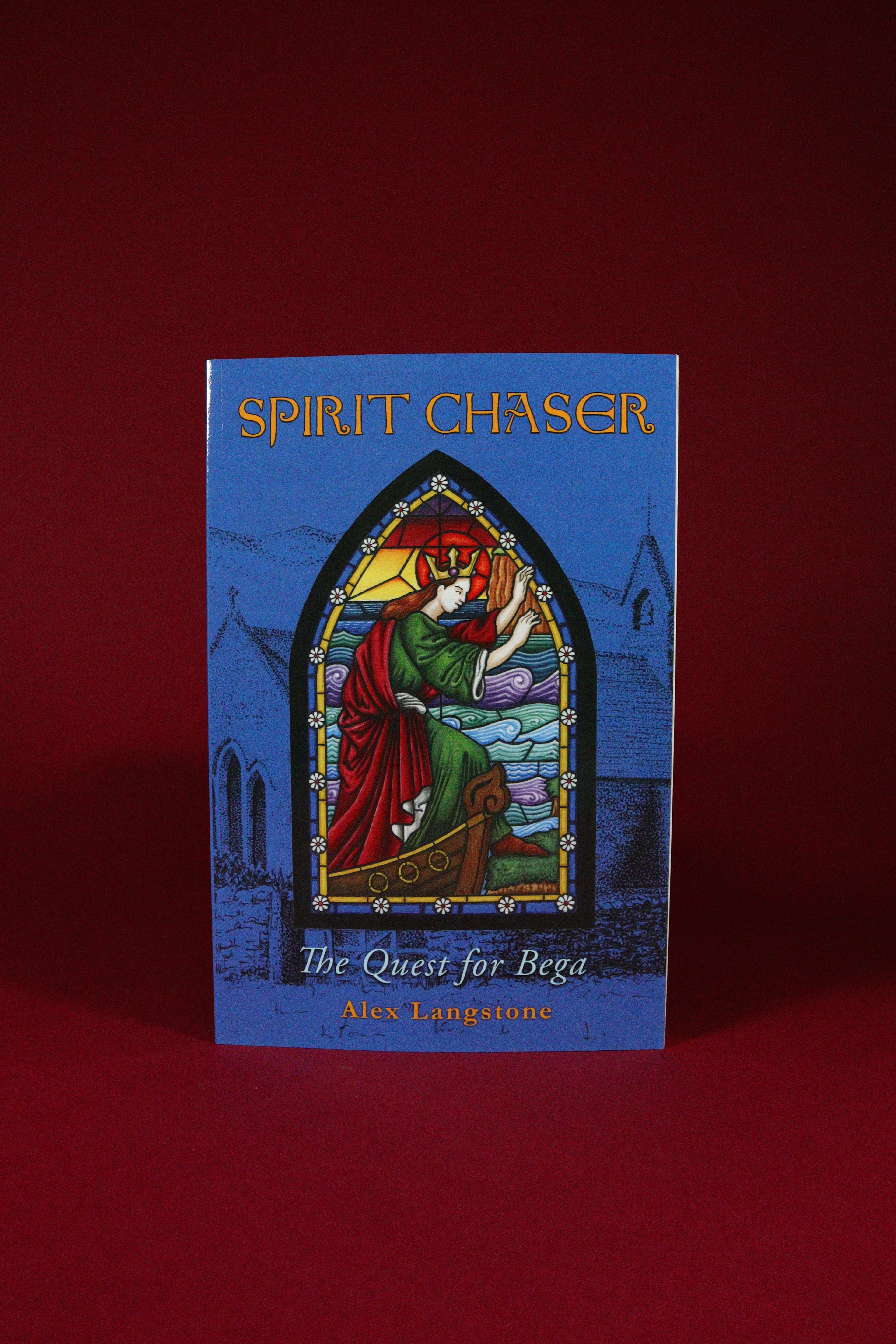 Book titled 'Spirit Chaser: The Quest for Bega' with a stained glass window design on a red background