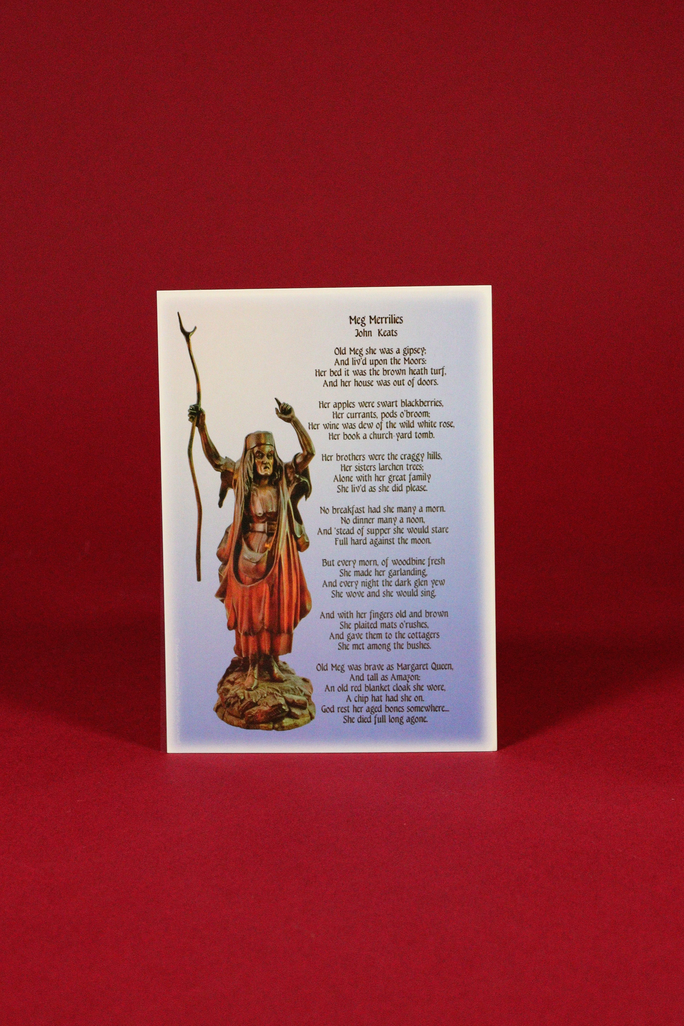 Card with a statue of a religious figure and text on a red background