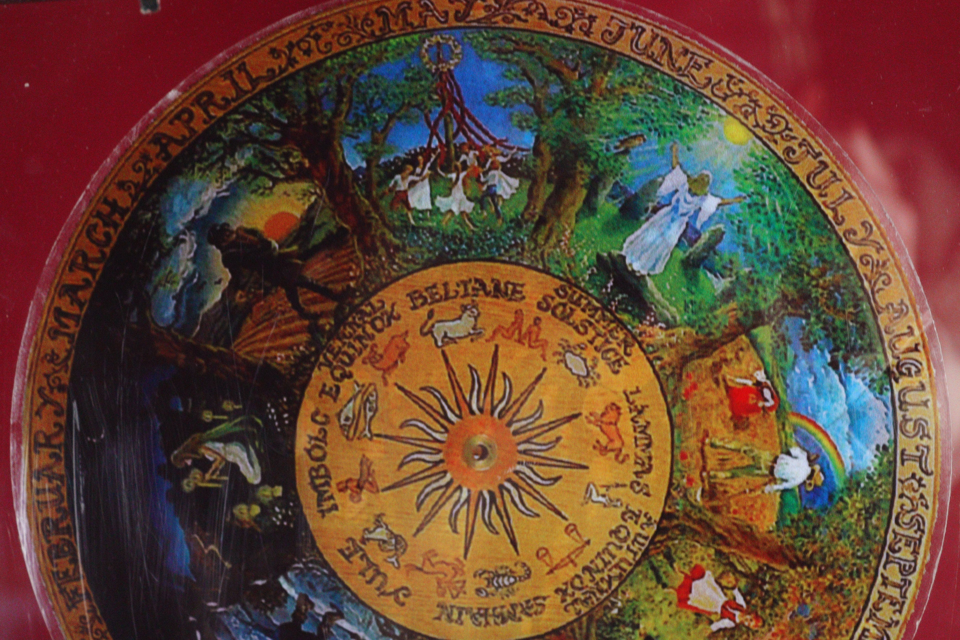 Decorative circular design with artistic illustrations and text on a red background