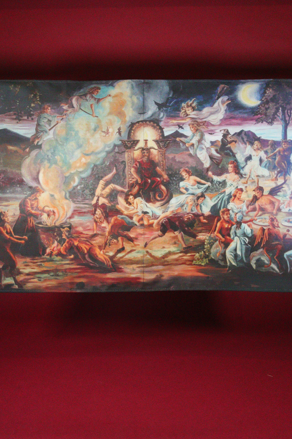Decorative tablecloth with a colorful scene of people and animals on a red background