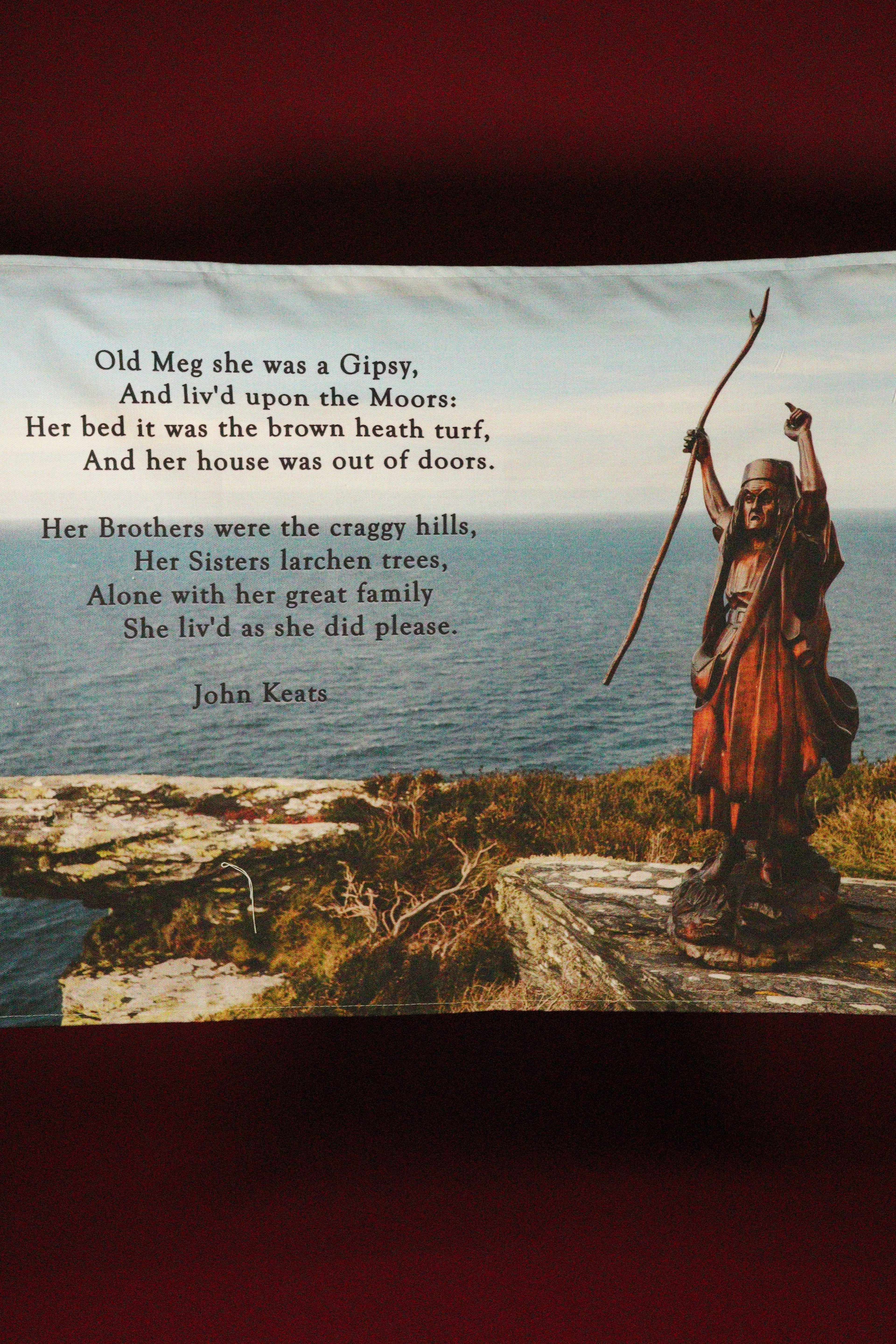 Statue of a figure with a bow and arrow on a cliff overlooking the ocean, with a poem by John Keats overlayed.