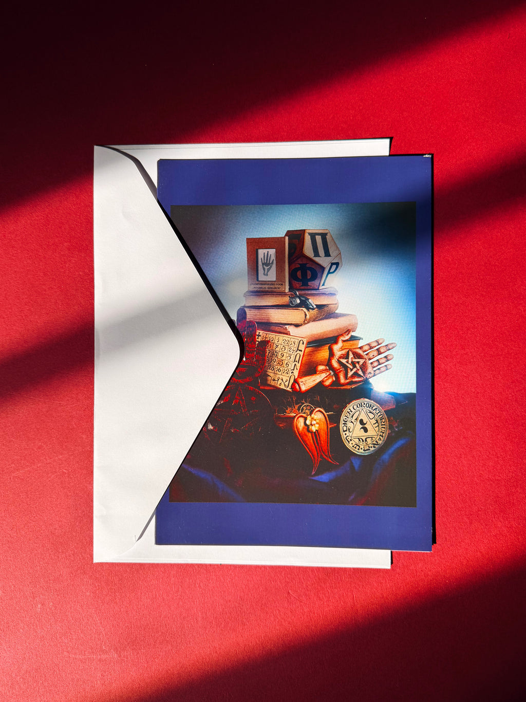 Card with a vintage wood carved objects on a red background