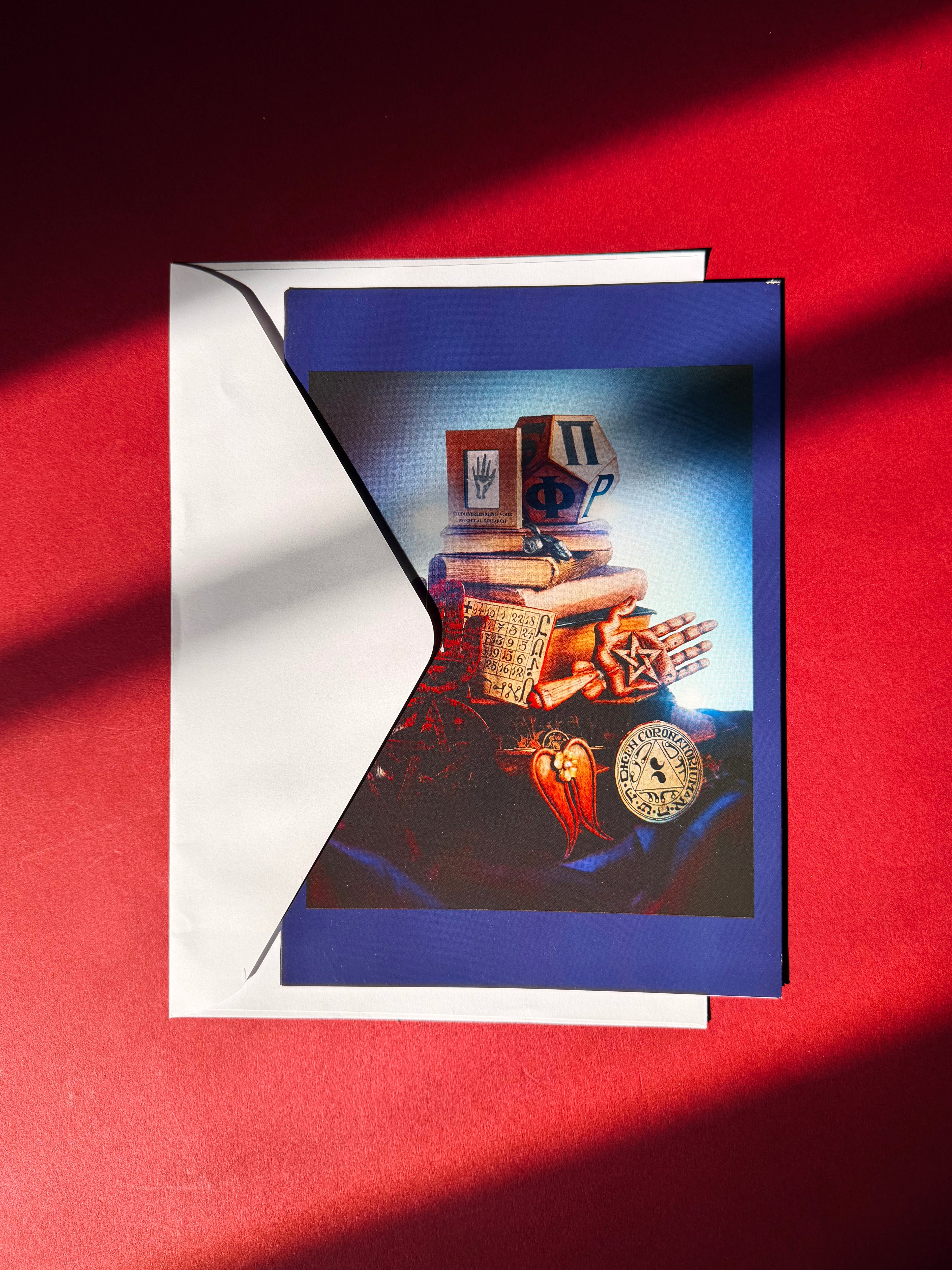 Card with a vintage wood carved objects on a red background