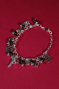 Silver bracelet with charms on a red background