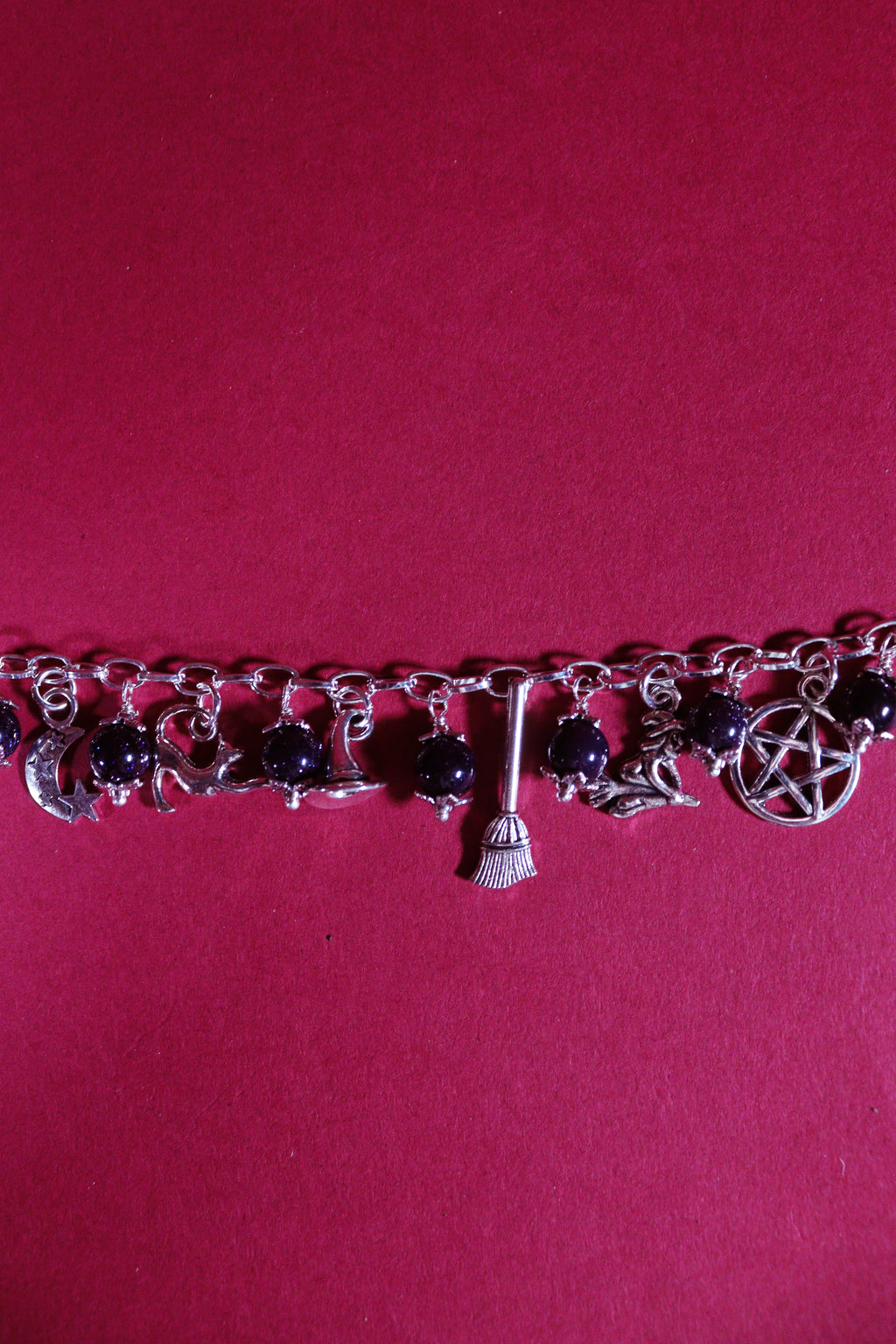Bracelet with charms on a pink background