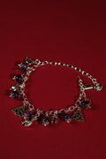 Silver bracelet with charms on a red background