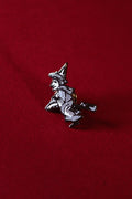 Witch pin on a red background