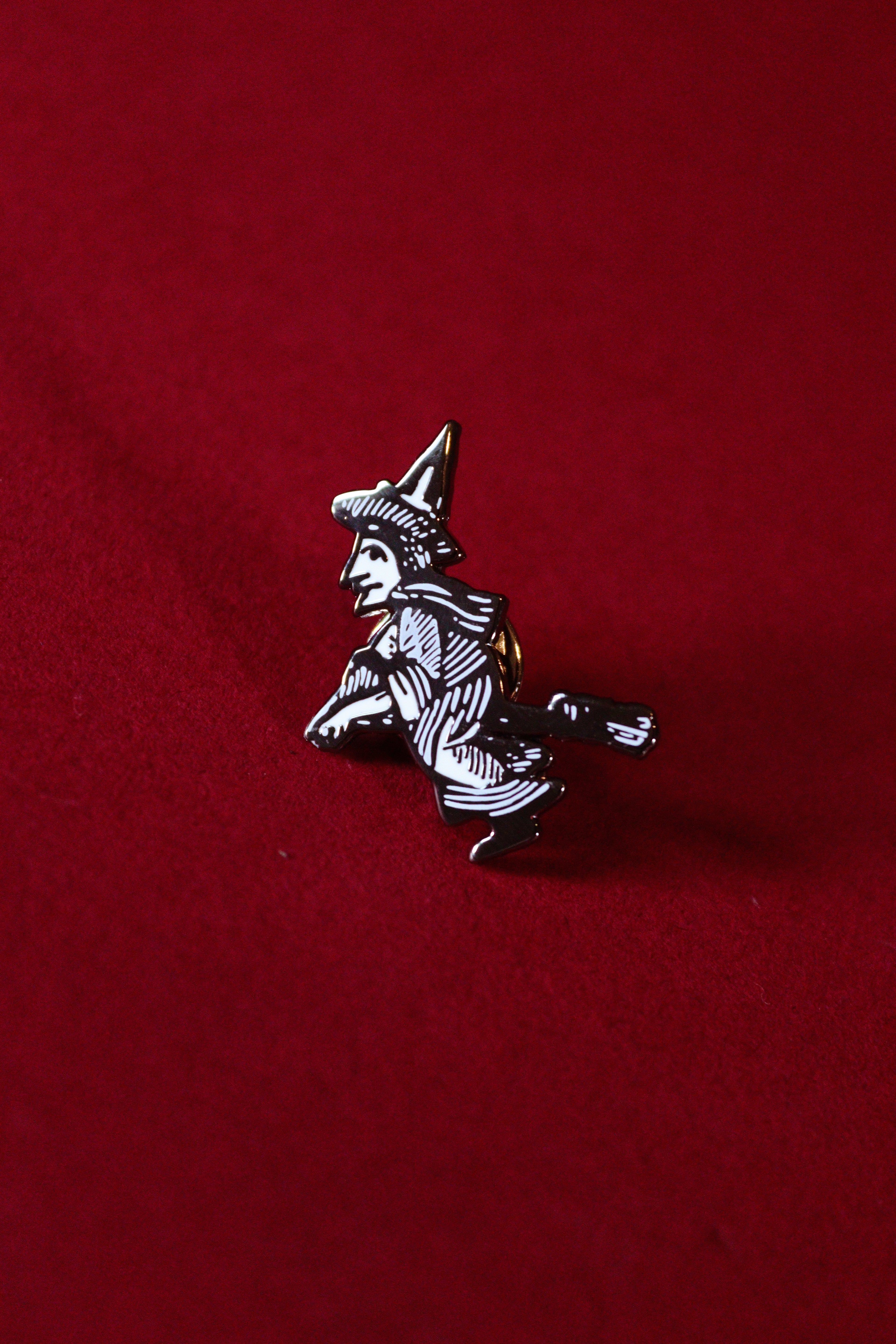 Witch pin on a red background