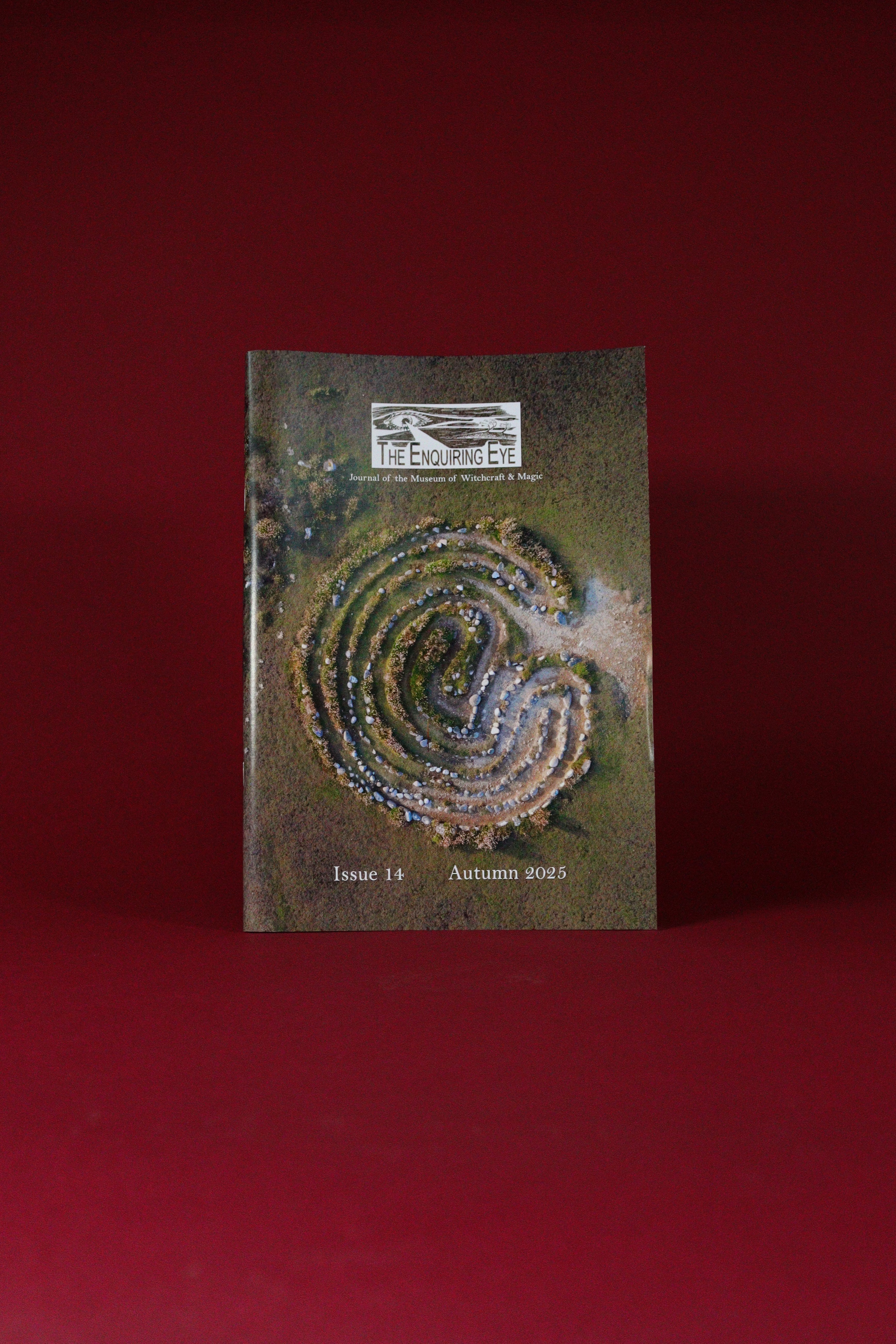 Magazine cover with a labyrinth design on a red background