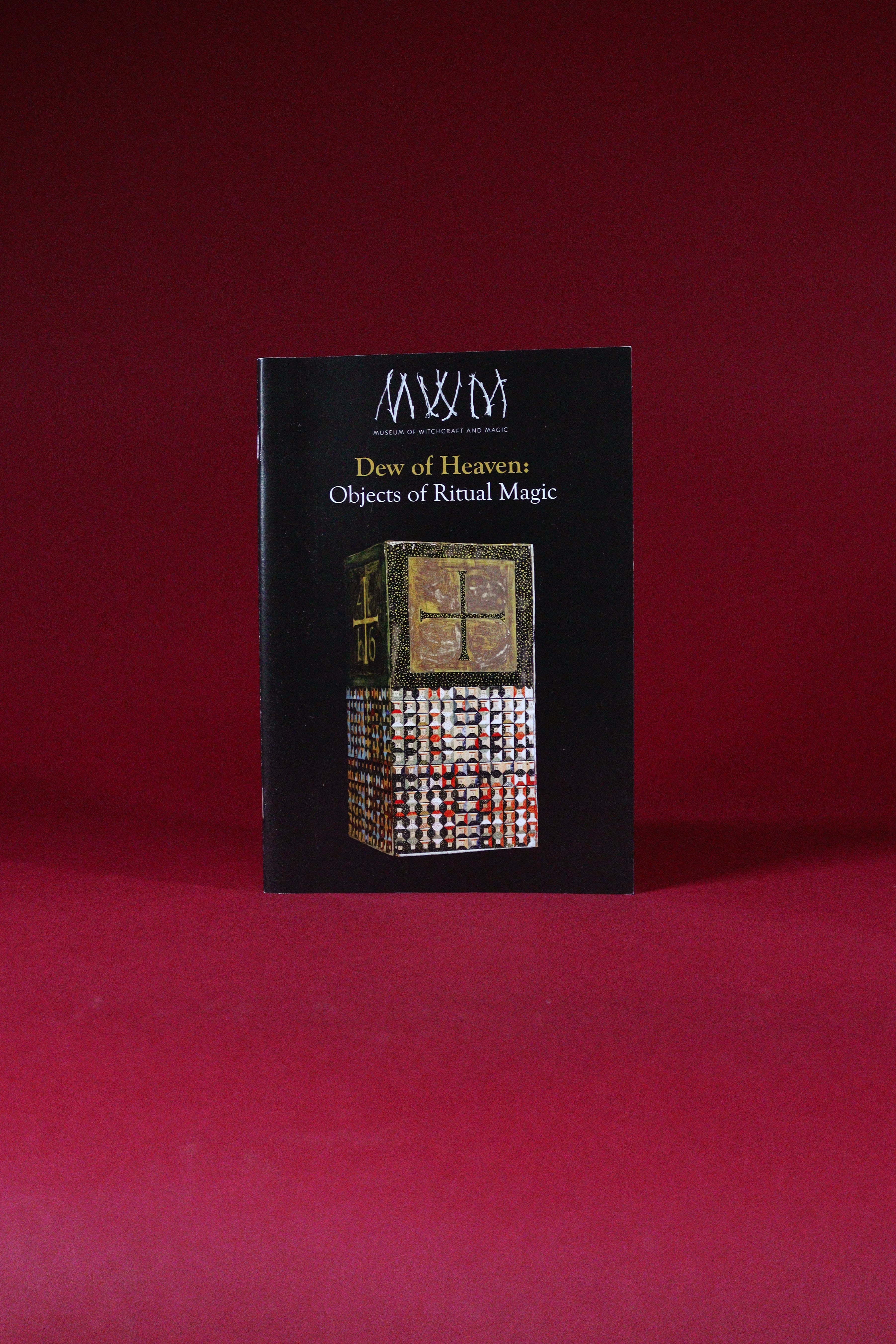Book titled 'Dew of Heaven: Objects of Ritual Magic' on a red background
