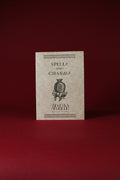 Booklet titled 'Spells and Charms' with a decorative cover on a red background