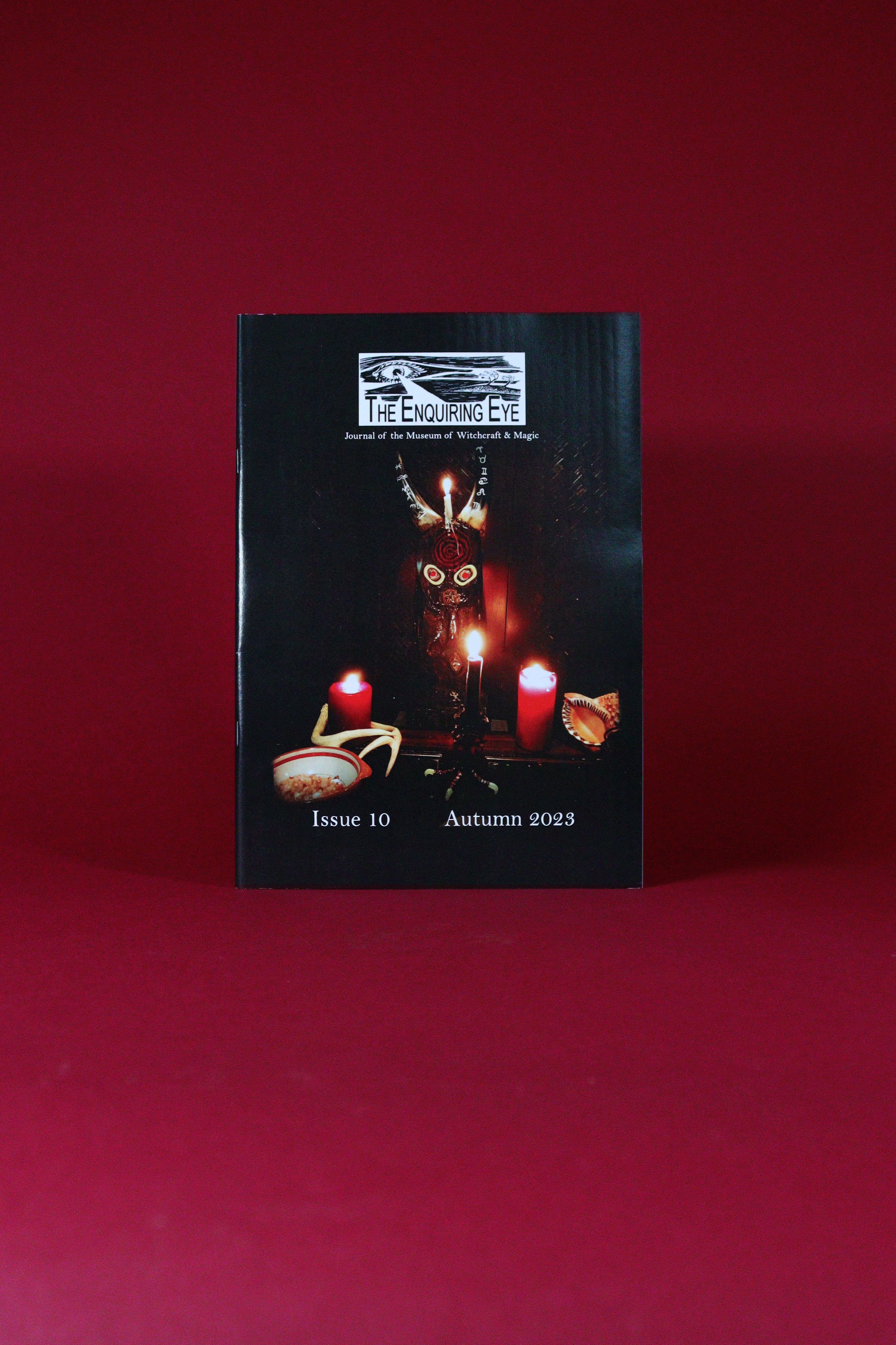 Booklet with 'The Enquiring Eye' logo on a red background
