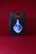 Book or magazine with a blue cover design on a red background