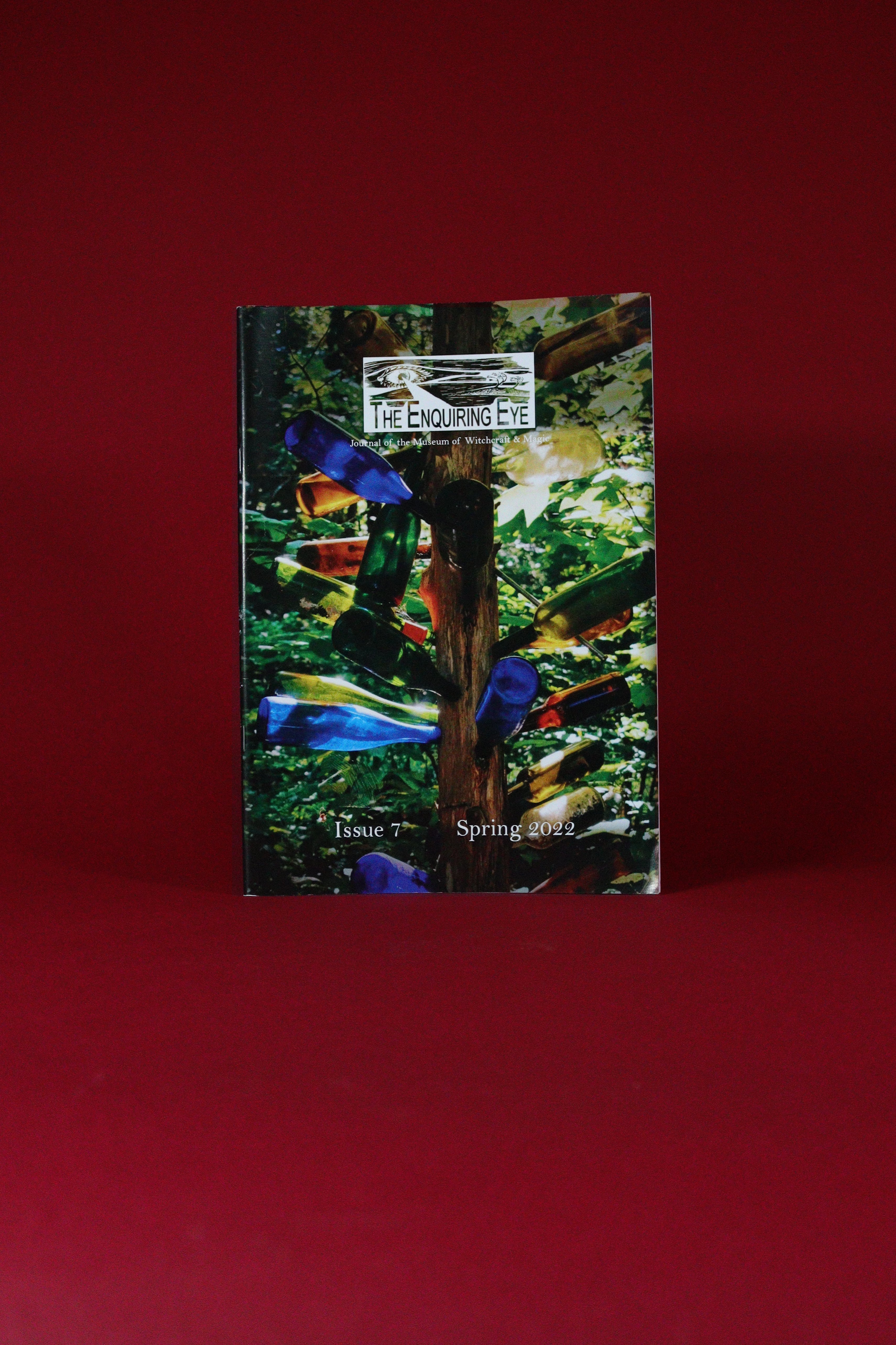 Magazine or book with a colorful cover featuring a cross and flowers on a red background
